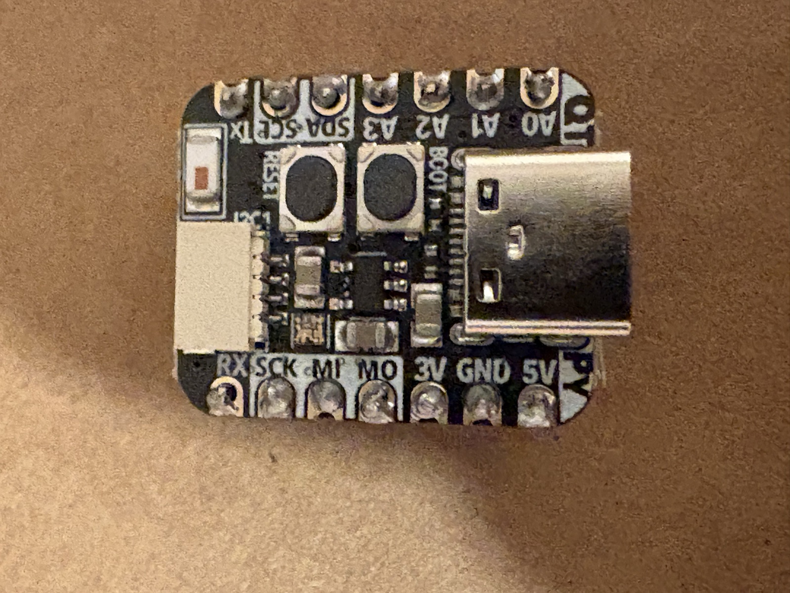 Adafruit QT Py ESP32-S3 macro shot showing pin labels